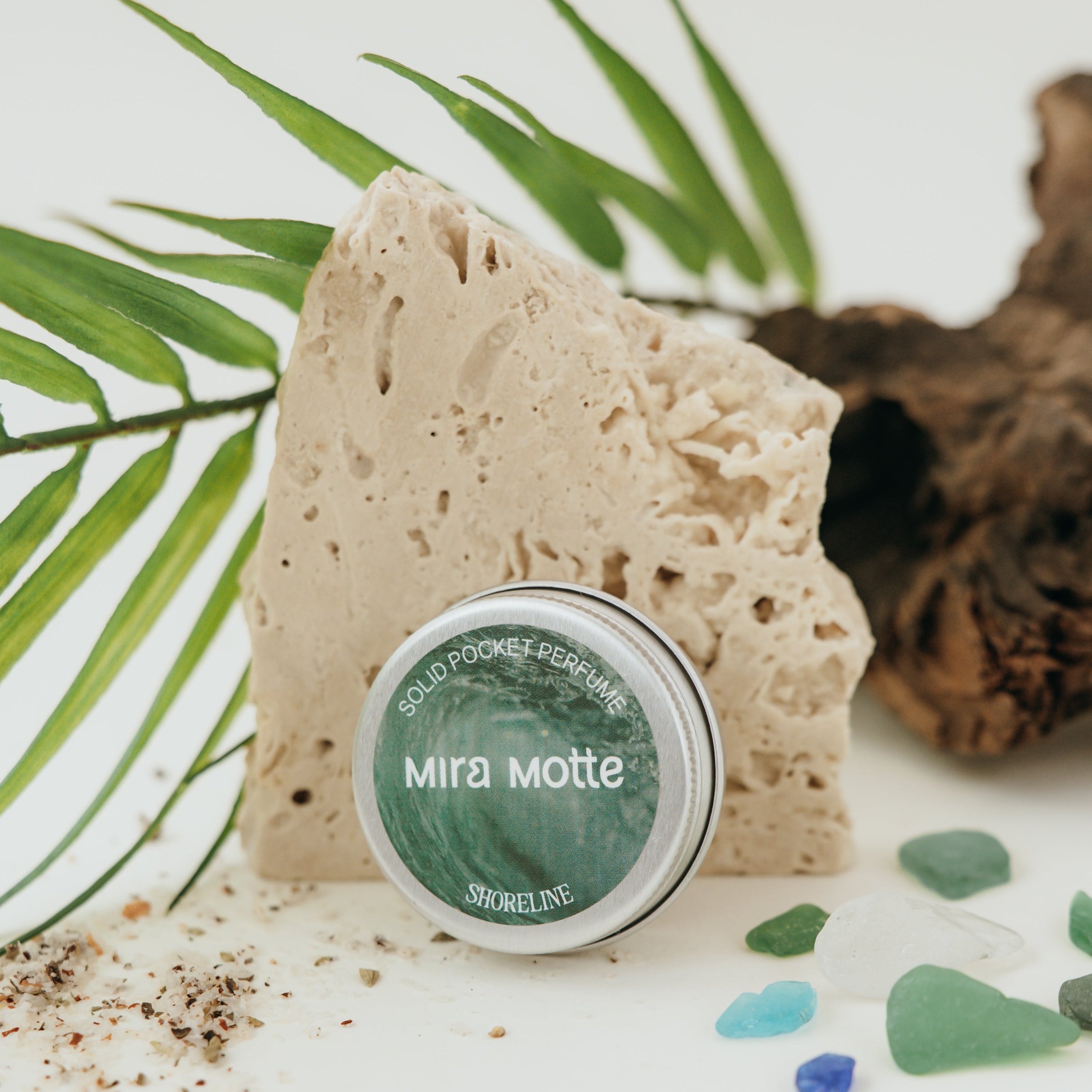 Solid Pocket Perfume labeled 'Mira Motte' with a natural sponge and green leaves on a light background