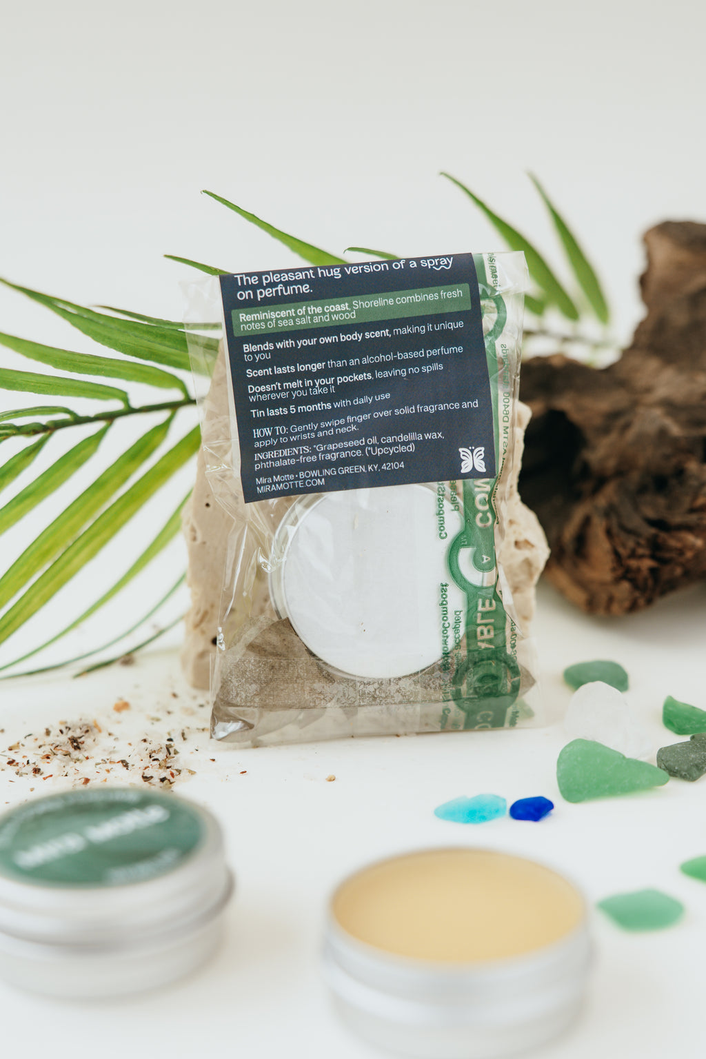 Cosmetic product with packaging on a white background with green leaves