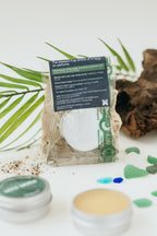 Cosmetic product with packaging on a white background with green leaves